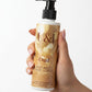 U&I Oud perfumed body lotion in a 200ml pump bottle held in a hand, featuring a gold and brown label design.