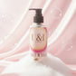 U&I Salt N Silk bath and shower gel bottle with a pump, surrounded by soap bubbles on a soft pink satin background.