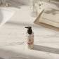 U&I Salt N Silk bath and shower gel in a 200ml pump bottle on a marble bathroom vanity with soft sunlight.
