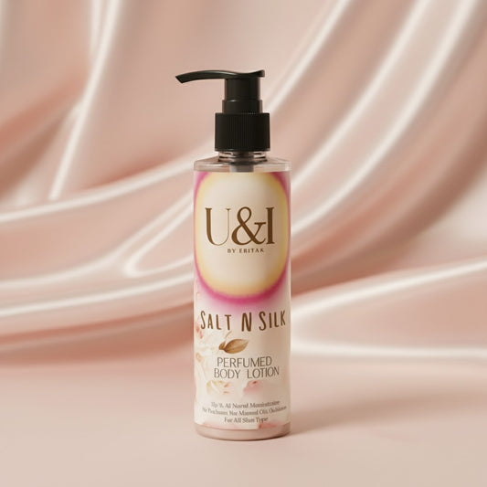 U&I Salt N Silk perfumed body lotion in a 200ml pump bottle against a soft, draped pink satin background.