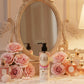 U&I Salt N Silk body lotion in a 200ml pump bottle on a vanity table with pink roses and perfume bottles.