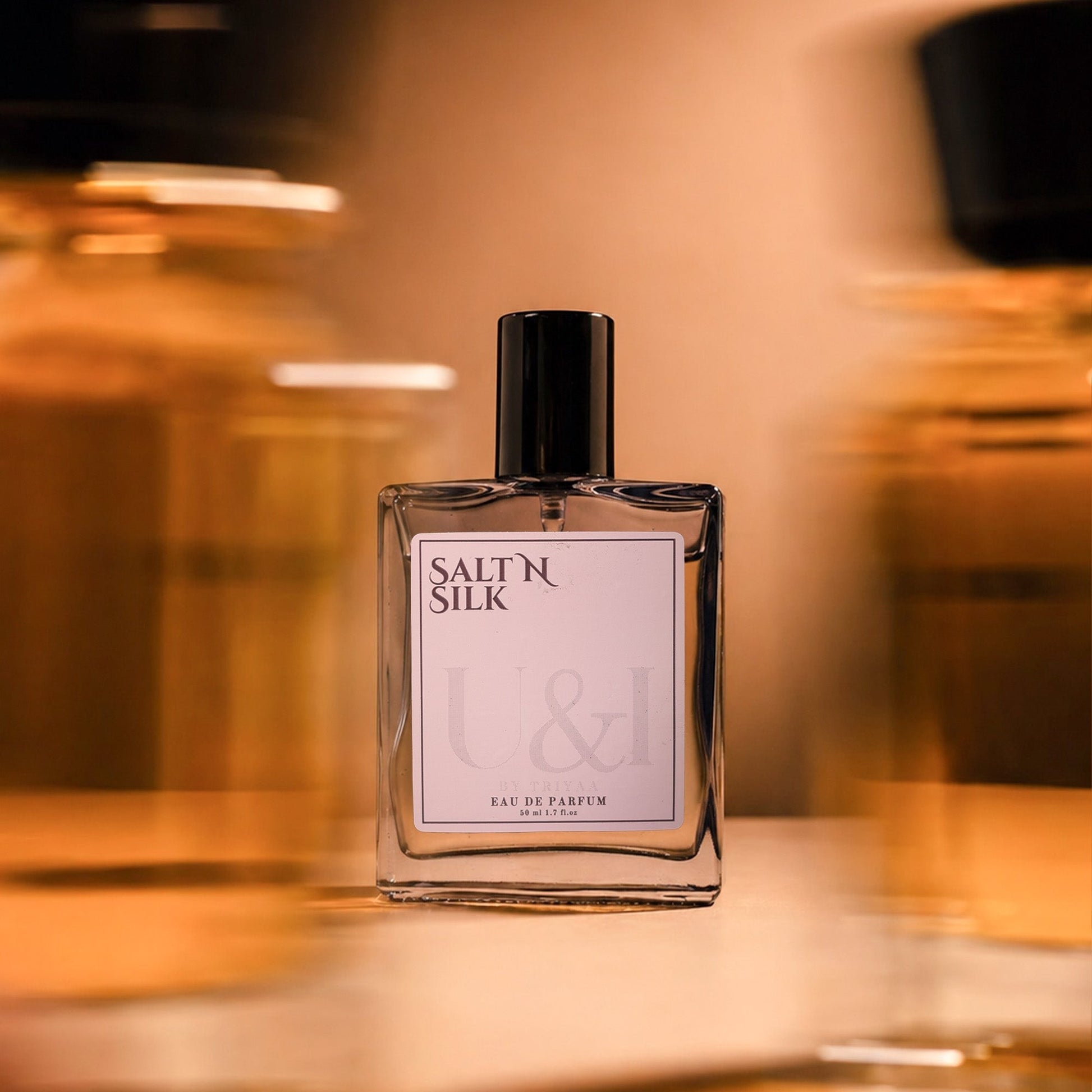 U&I Salt N Silk eau de parfum in a clear glass bottle with a black cap, featuring floral and musky fragrance notes.