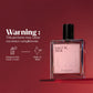 U&I Salt N Silk eau de parfum in a clear glass bottle with a pink label against a deep red background.