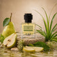 U&I Breeze of Eden perfume bottle surrounded by fresh pears and green leaves on a stone surface
