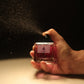 U&I Her Highness perfume bottle being sprayed, featuring a square glass bottle with velvet floral and amber scent.