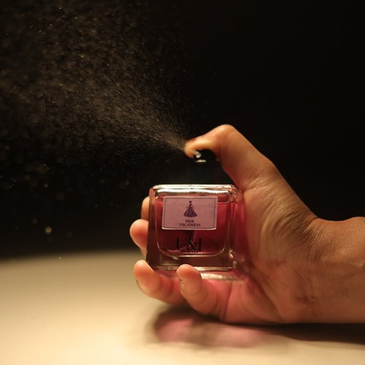 U&I Her Highness perfume bottle being sprayed, featuring a square glass bottle with velvet floral and amber scent.