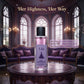 U&I Her Highness eau de parfum in a glass bottle with a purple label, set on a table in a luxurious palace room.
