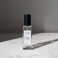 U&I Manly Affair eau de parfum in a clear glass rectangular bottle with a black cap on a white marble surface.